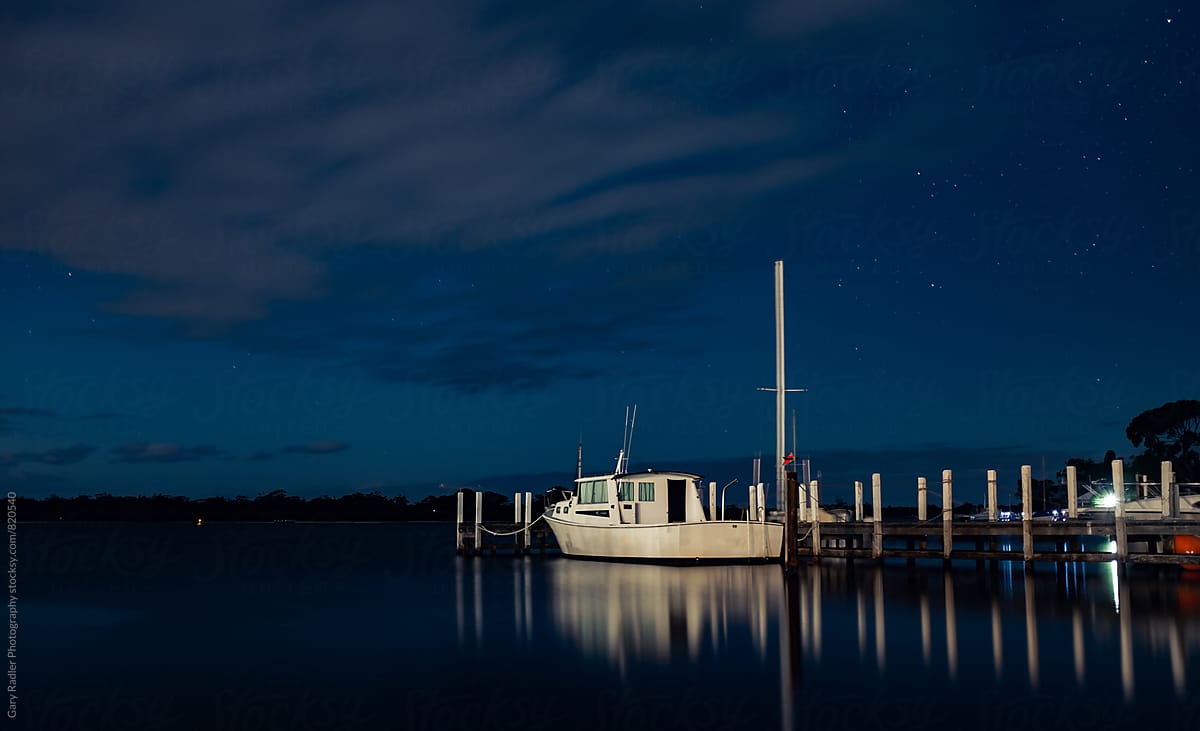 White Boat tied to a Pier at Night