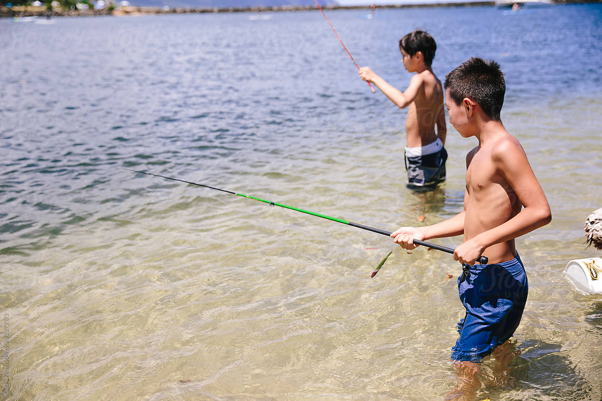 Two Boys Fishing For Minnows In The Ocean Along The Coastline Of Hawaii by  Stocksy Contributor Curtis Kim - Stocksy