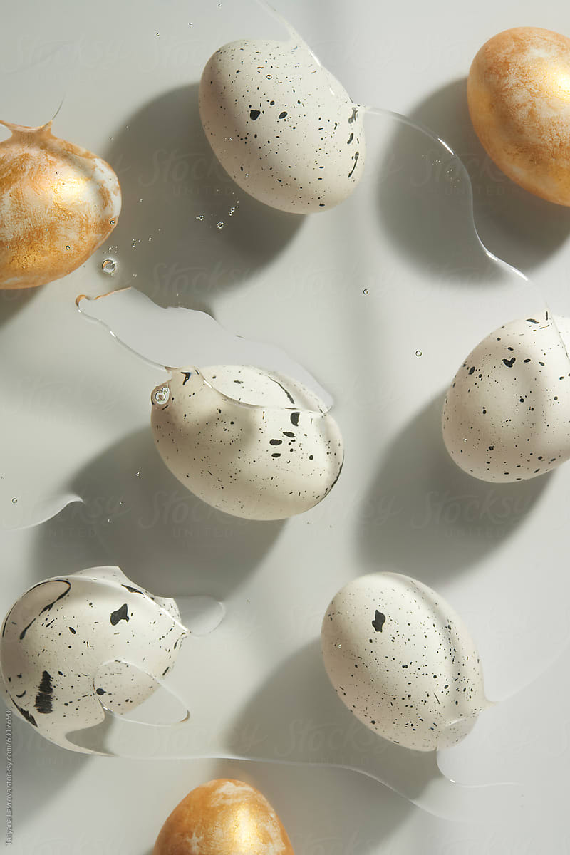 Different painted eggs on white surface under the sunlight.