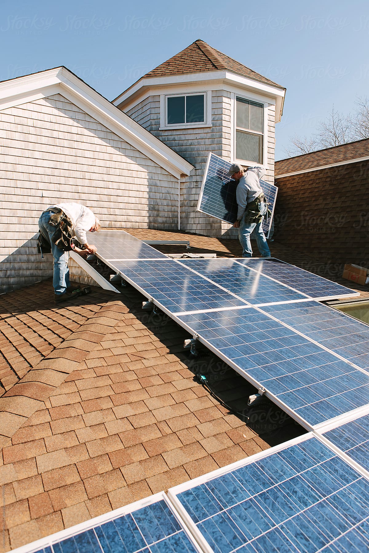 blue collar worker solar Installation on roof of Home
