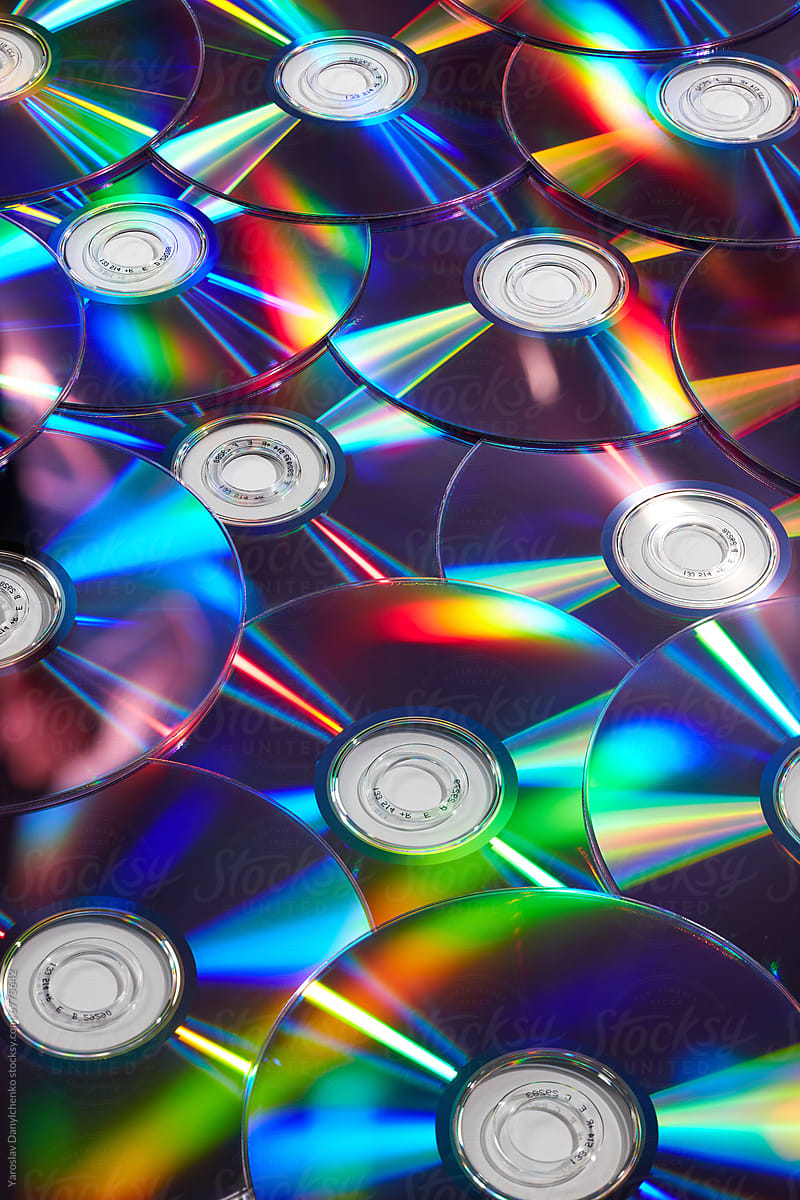 Seamless pattern of scattered old cd discs with rainbow reflection