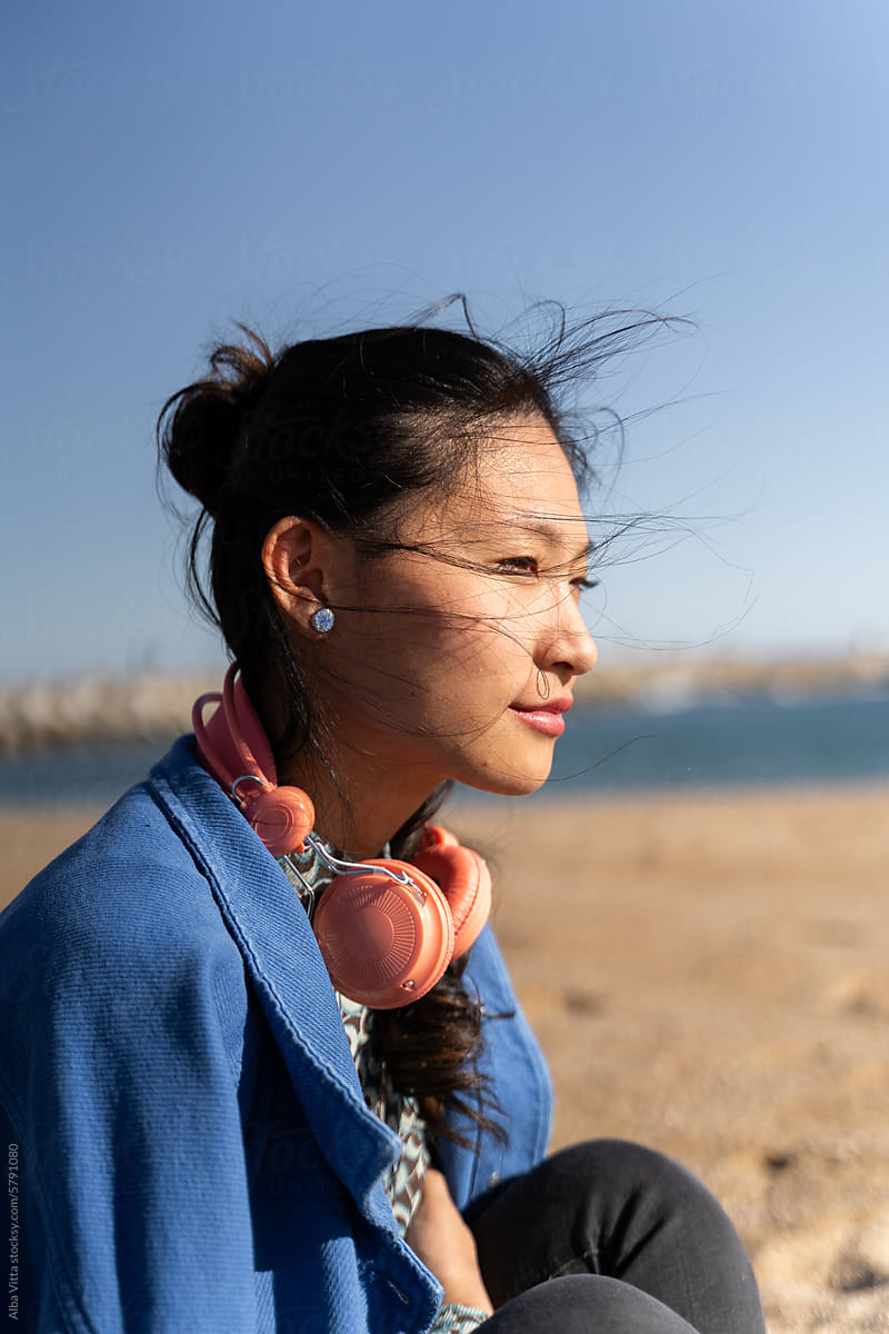 Woman with headphones at beach