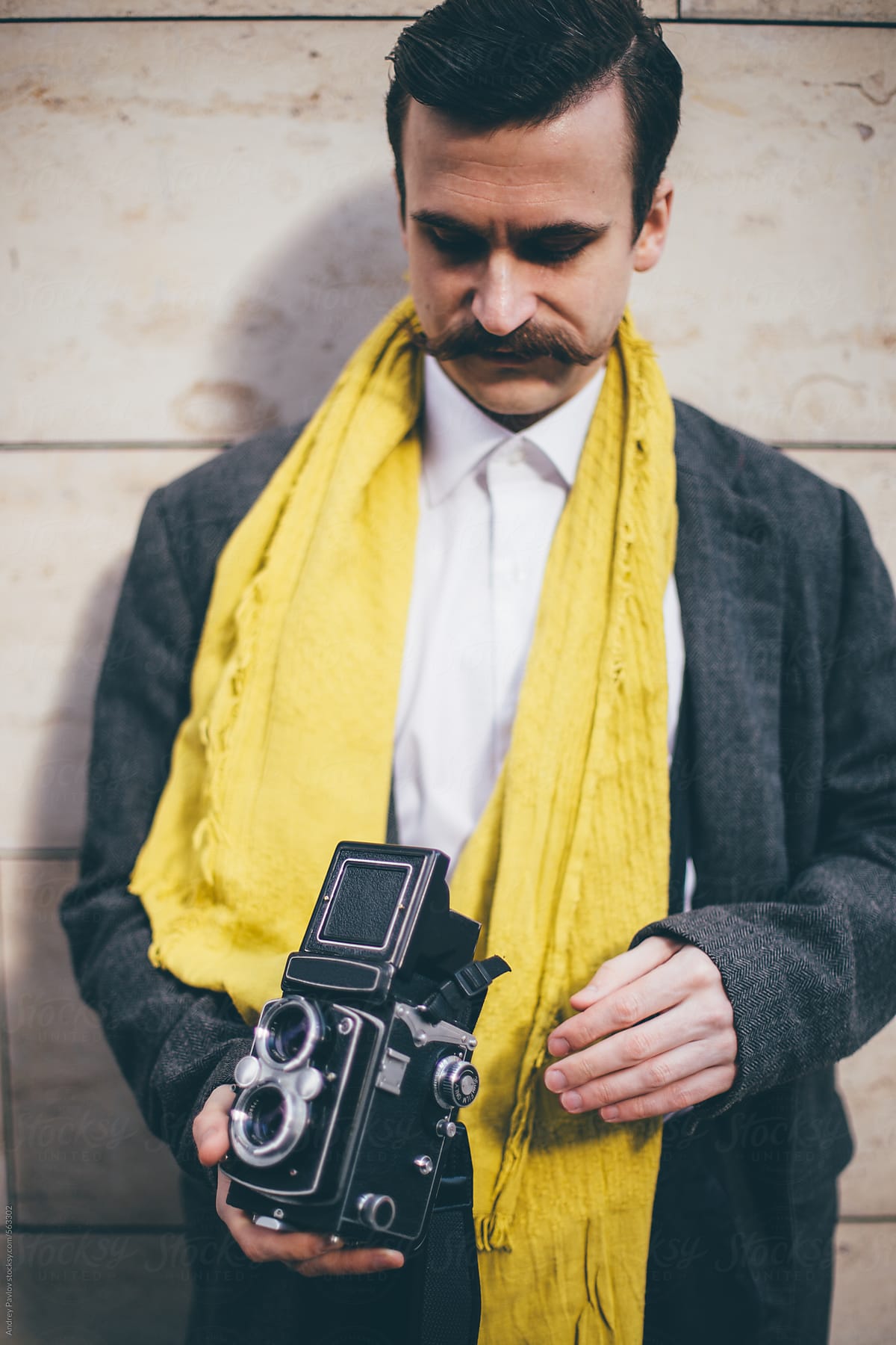 Mustached photographer with old analog camera