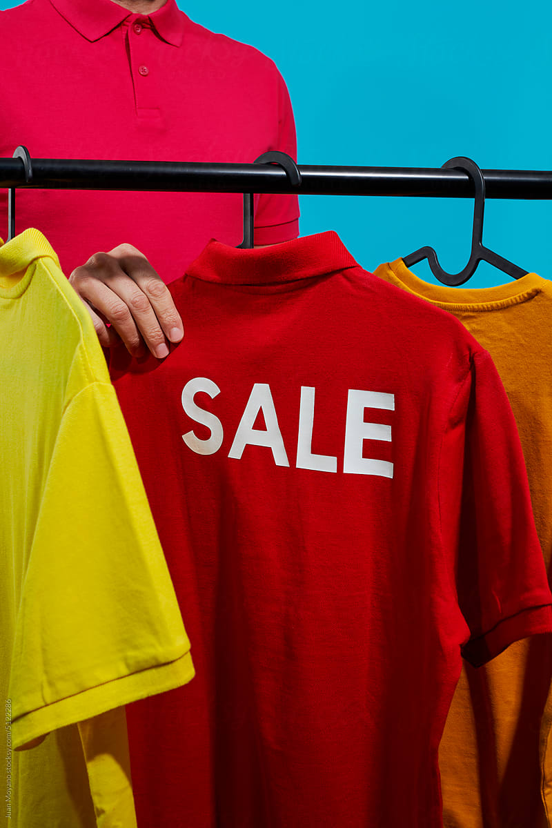 man grabs a t-shirt with the word sale