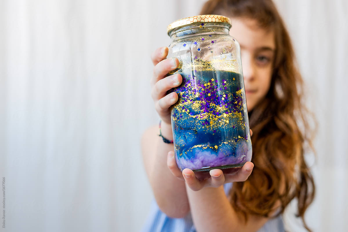 Little girl showing her galactic pot at camera