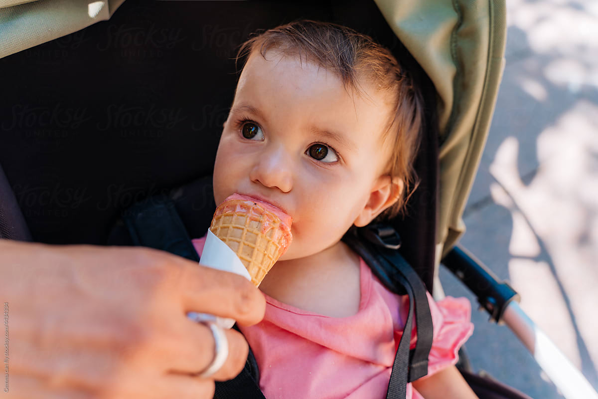UGC - Baby girl eating icecream sitting on stroller