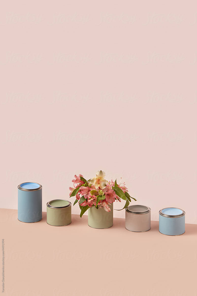 Fresh spring flowers placed inside paint tin cans