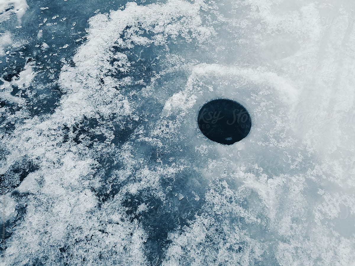 Ice Fishing Hole On Frozen Lake by Stocksy Contributor Alicia Magnuson  Photography - Stocksy