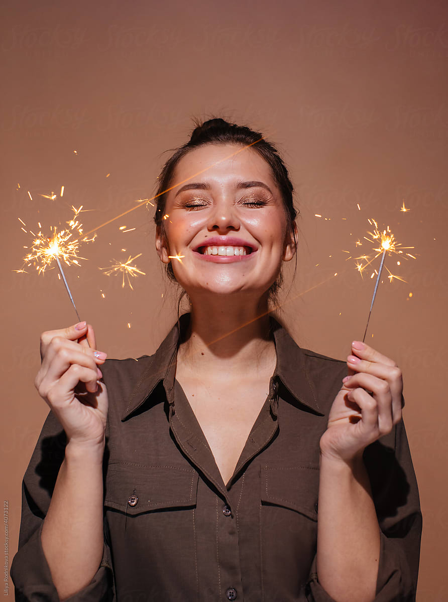 Happy woman with sparklers