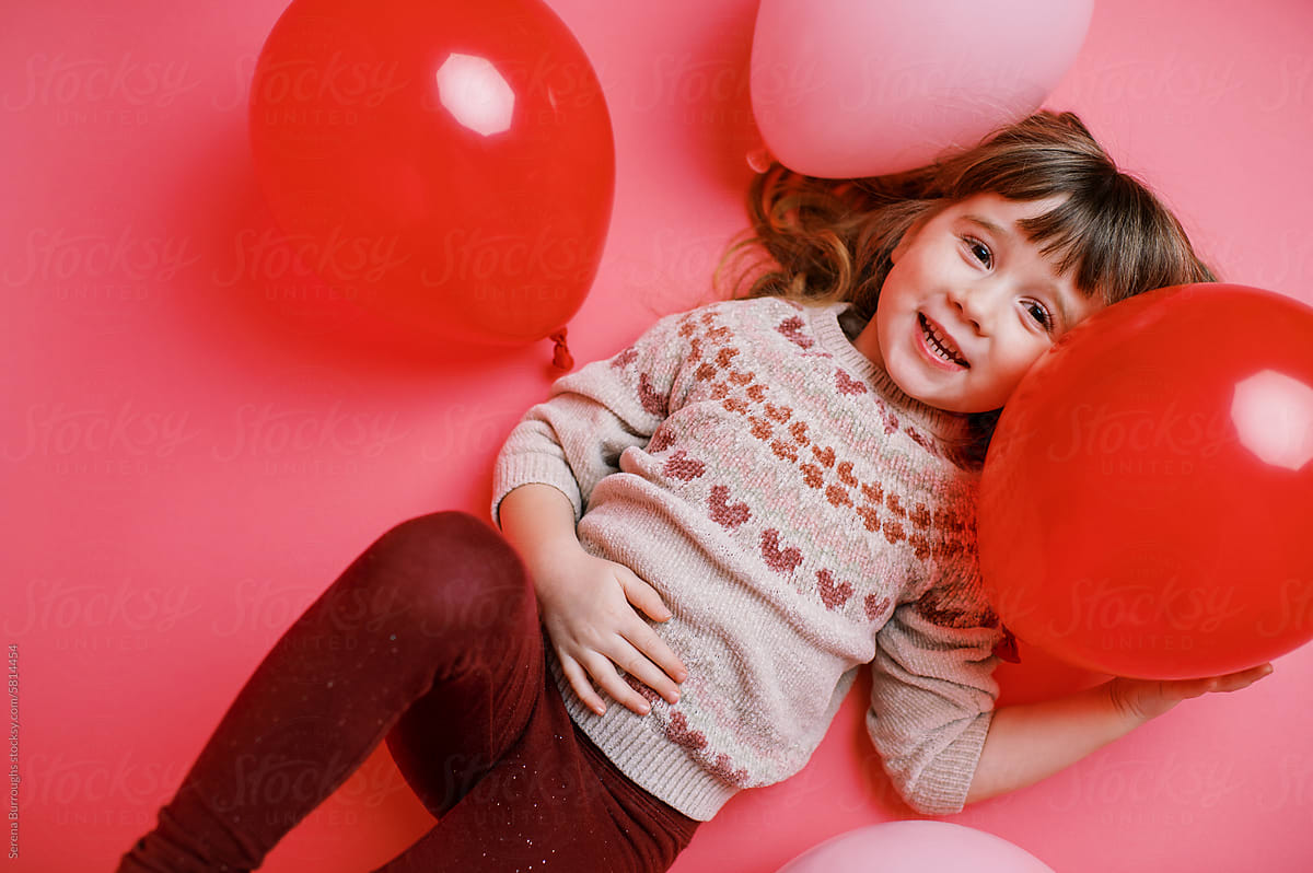 Happy toddler on pink backdrop
