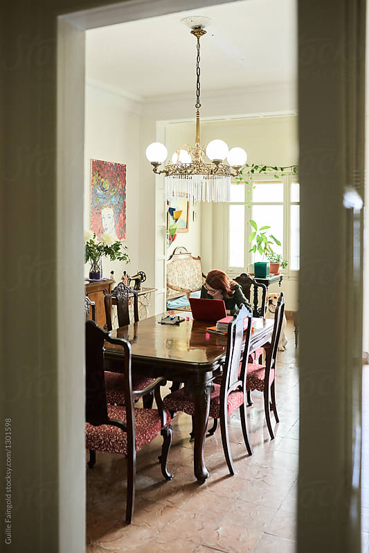 Woman working in vintage dining room.