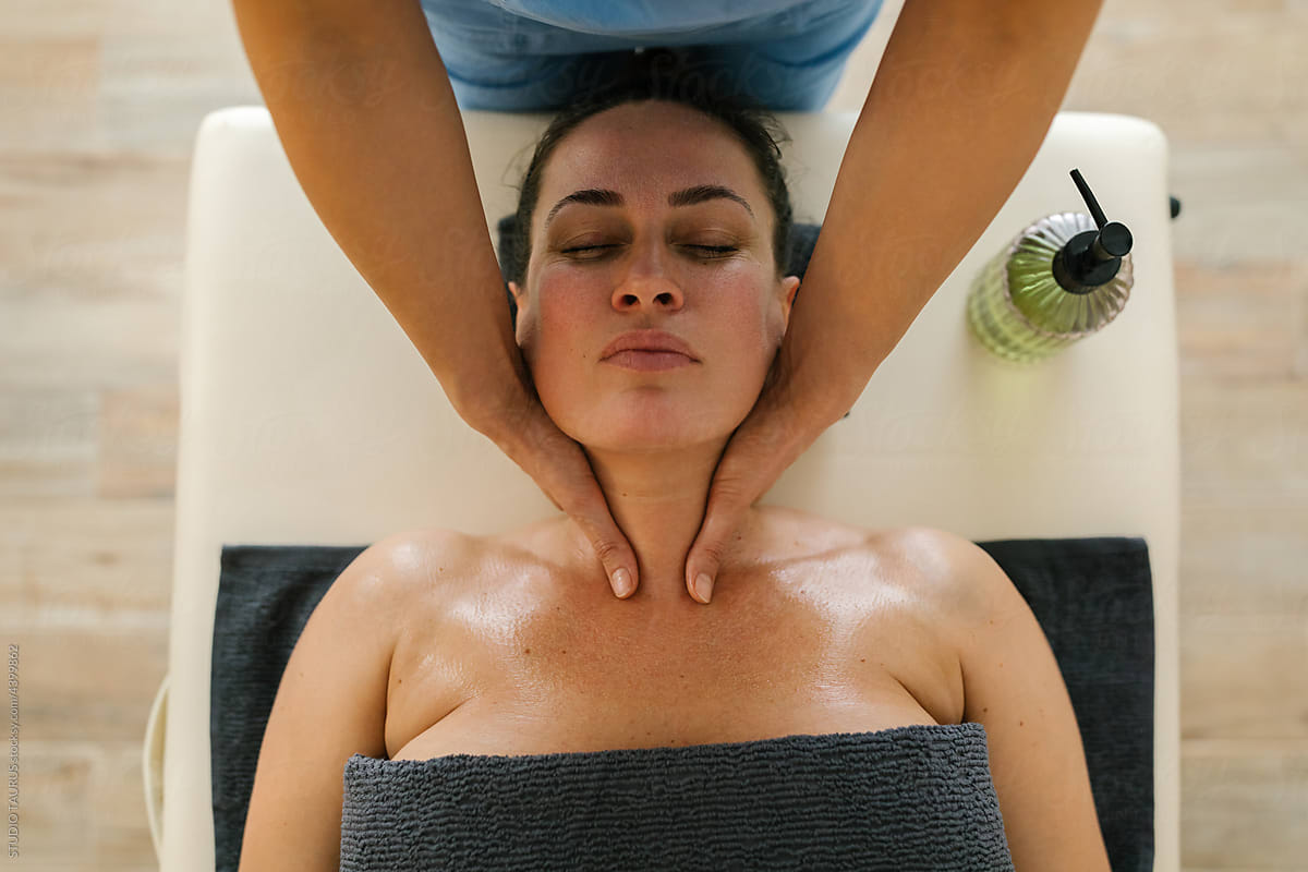 Mature woman at spa having face and neck treatment