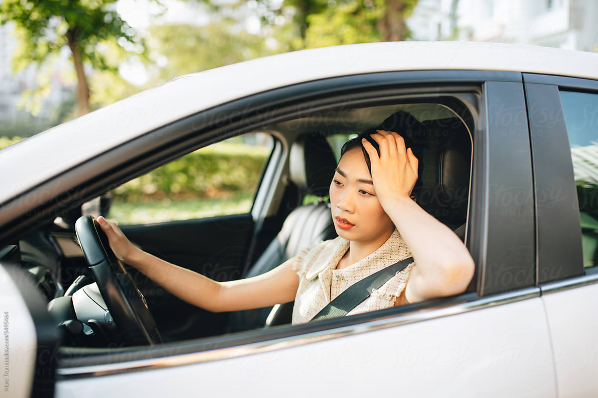 Asian woman driving her car, conceptual expression and gesture