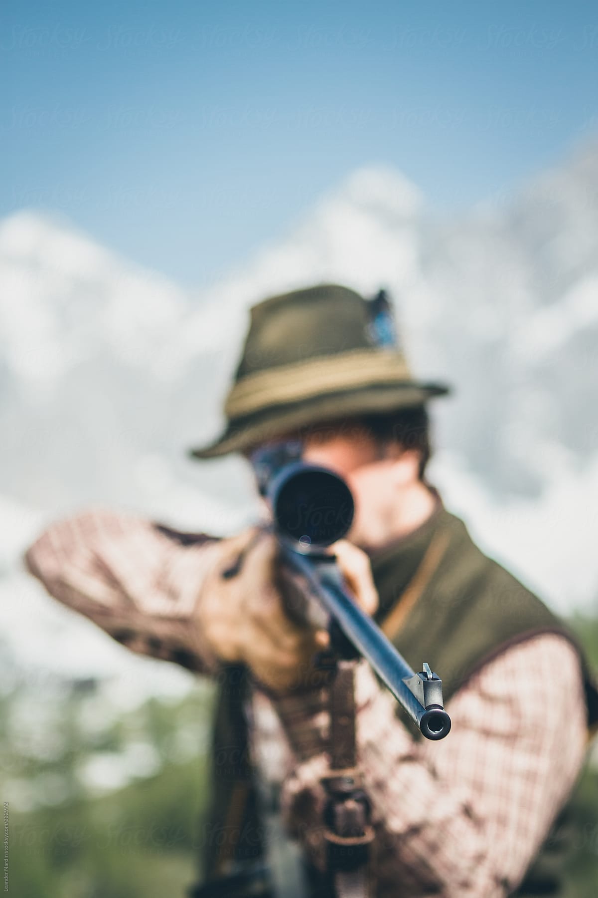 portrait of a hunter aiming focused on the gun barrel