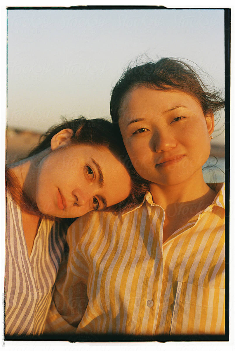 Film close-up portrait of two young girls by the ocean