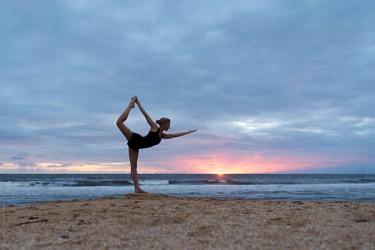 Woman Exercising On The Beach At Sunrise