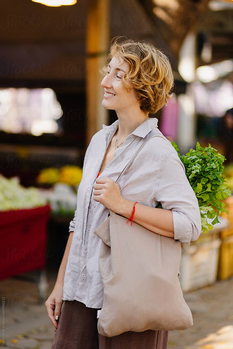 Happy young woman standing in authentic market