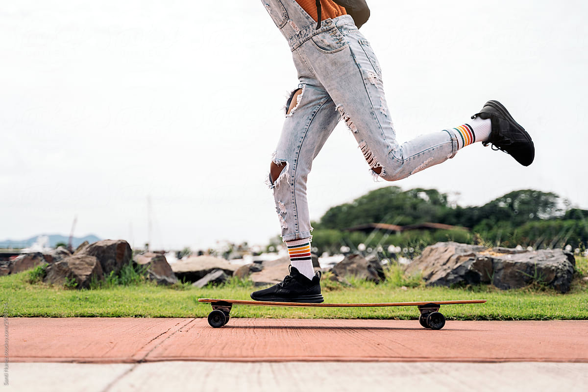 Unrecognizable afro woman riding skateboard