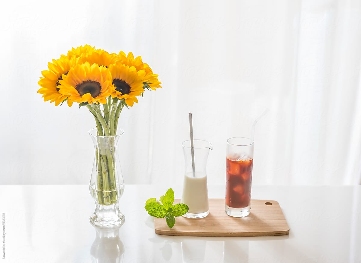 Delicious milk tea and beautiful sunflower on table.
