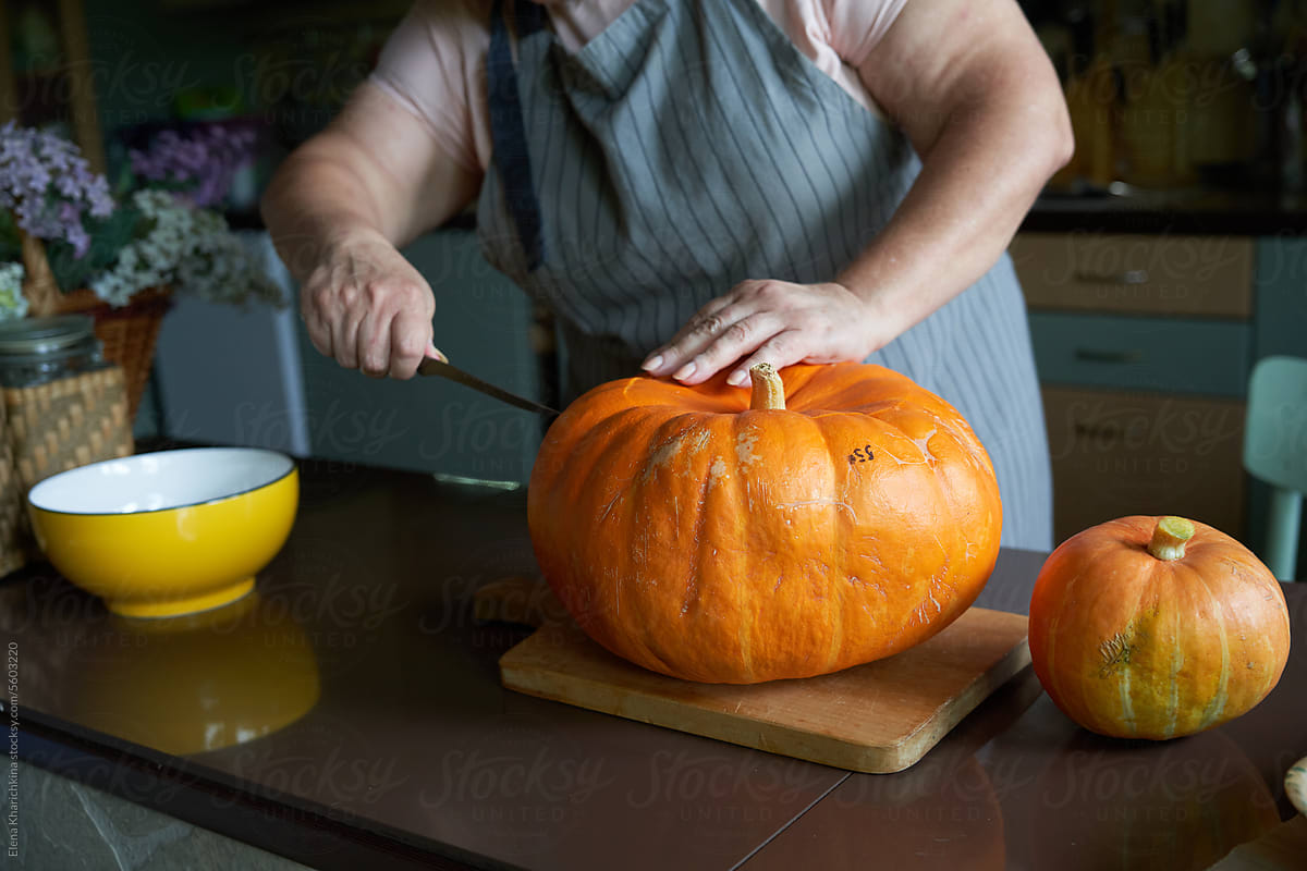 Carving: Woman Working On Face Of Jack-O-Lantern