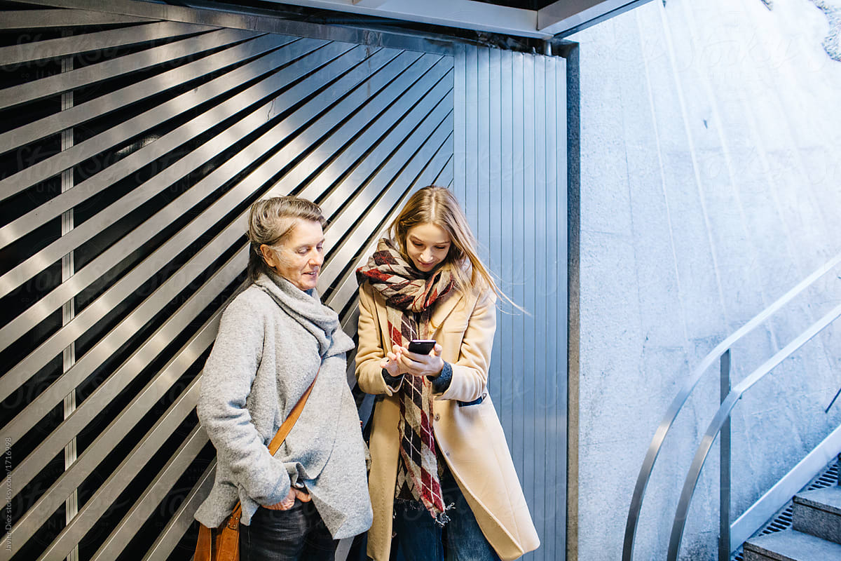 Women using smartphone in subway