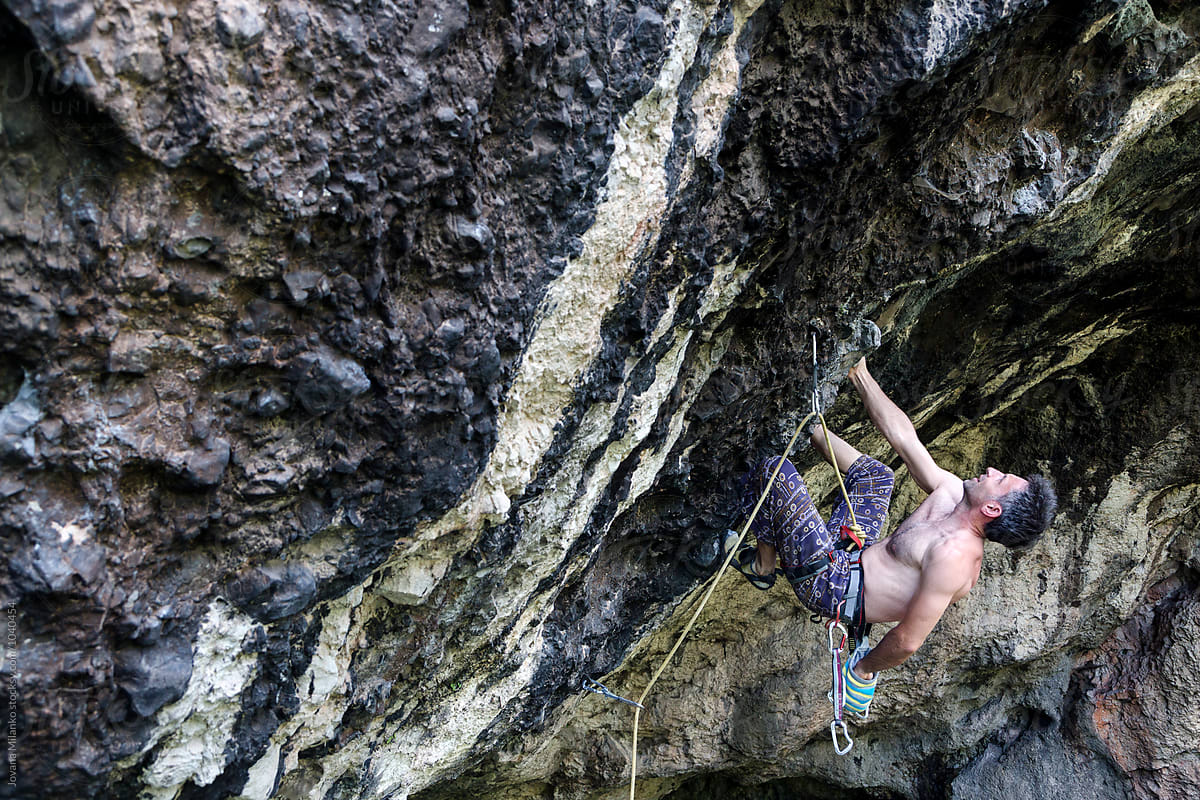Free climber leading a route on a natural rock outdoor
