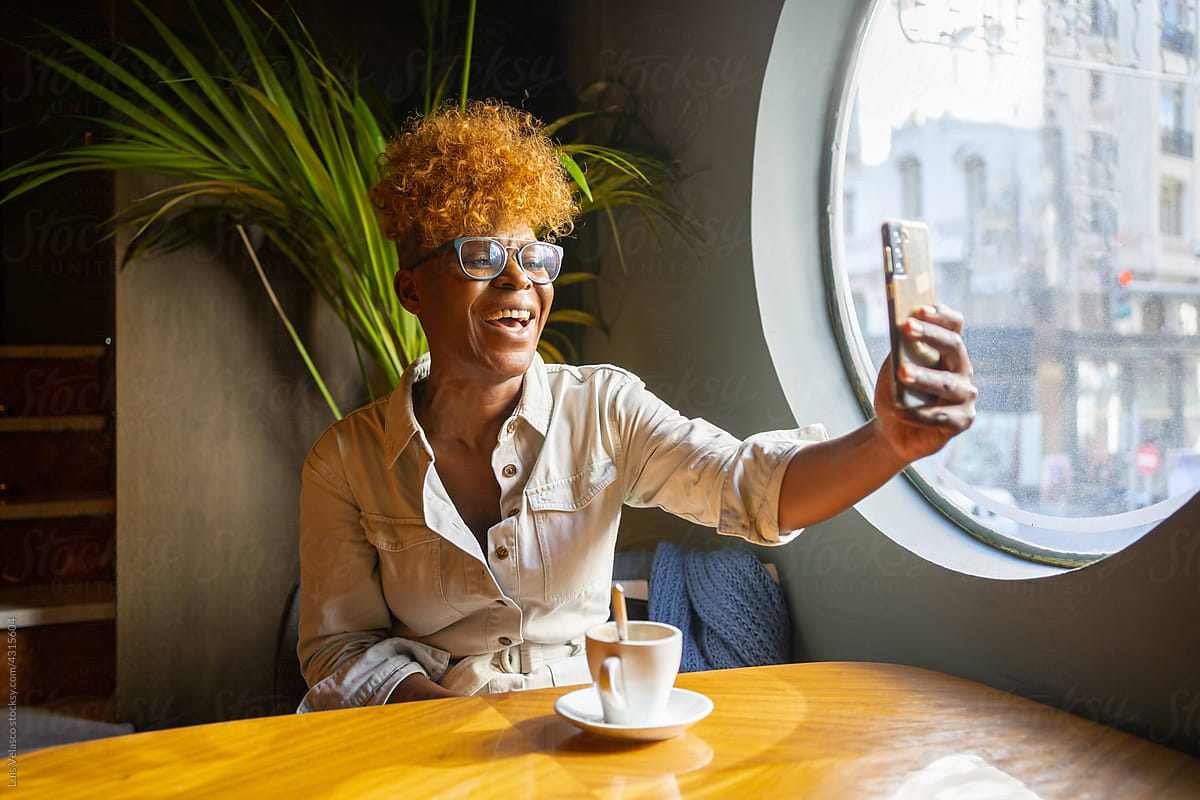 Happy Black Woman Having A Video Call In A Cafe.