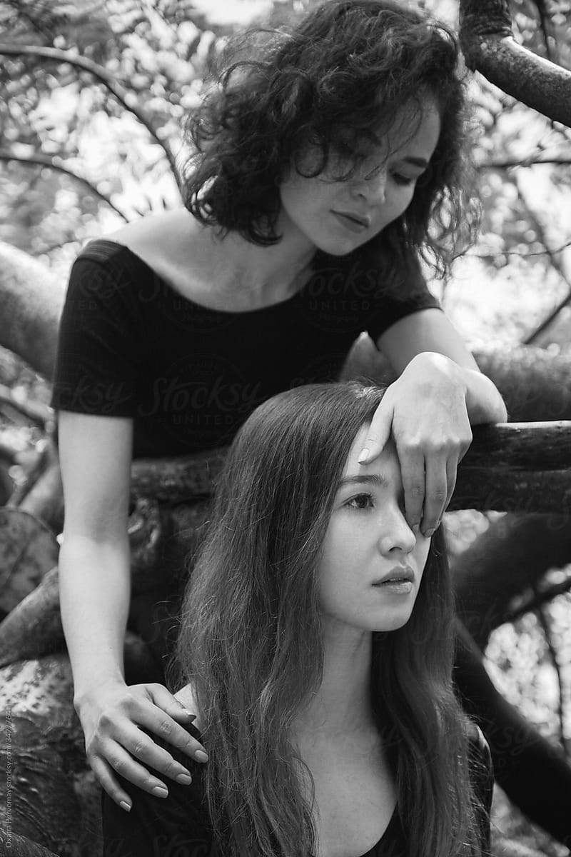 Two girls in the branches.