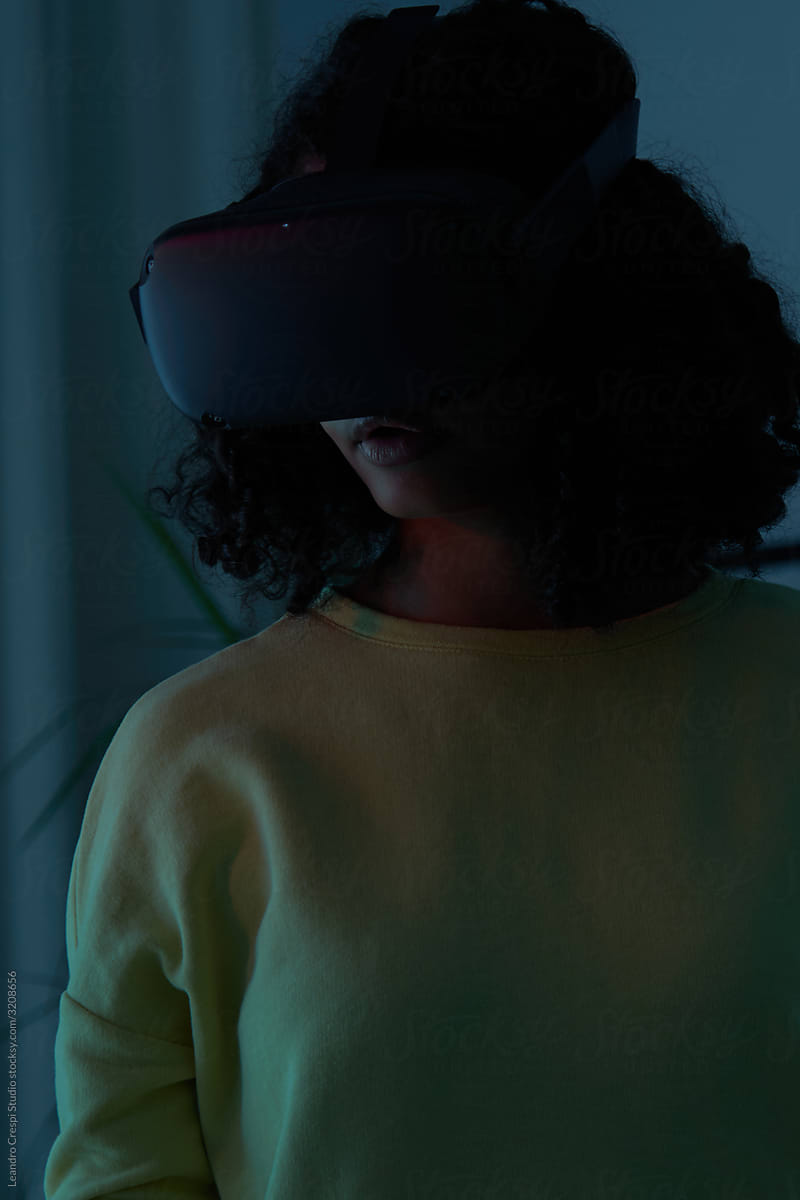 Woman watching VR experience at night