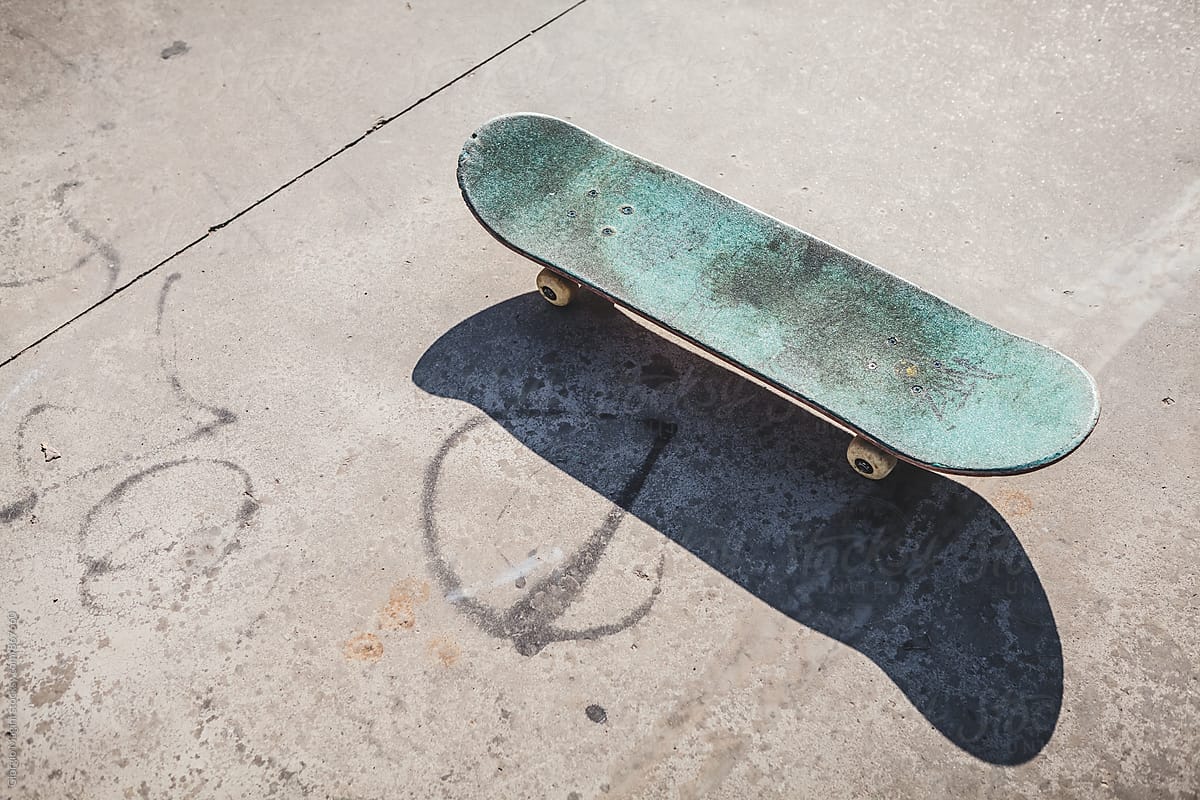 Worn Skateboard on Concrete Paving