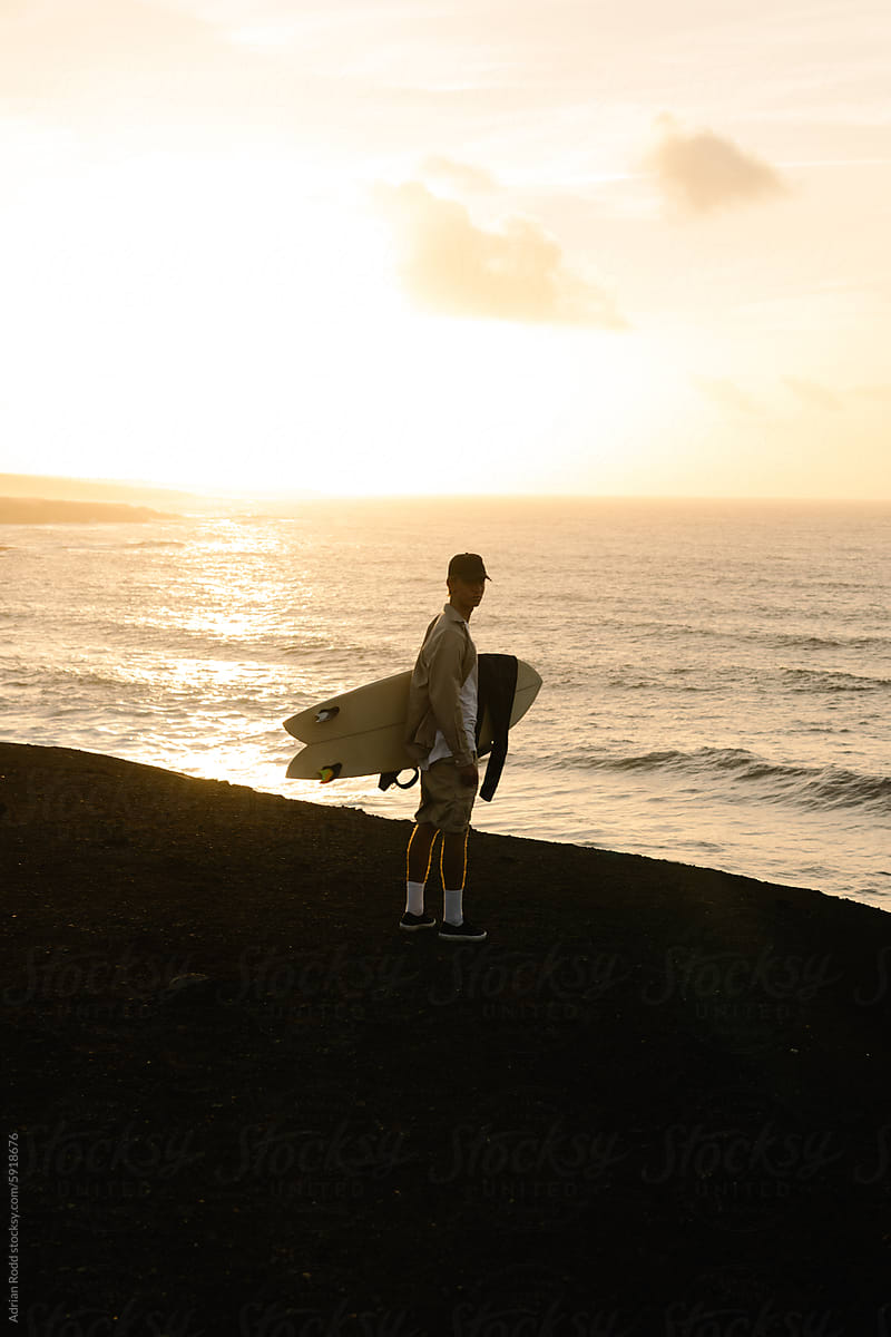 Wide shot portrait of a surfer waiting for the tide to rise to surf