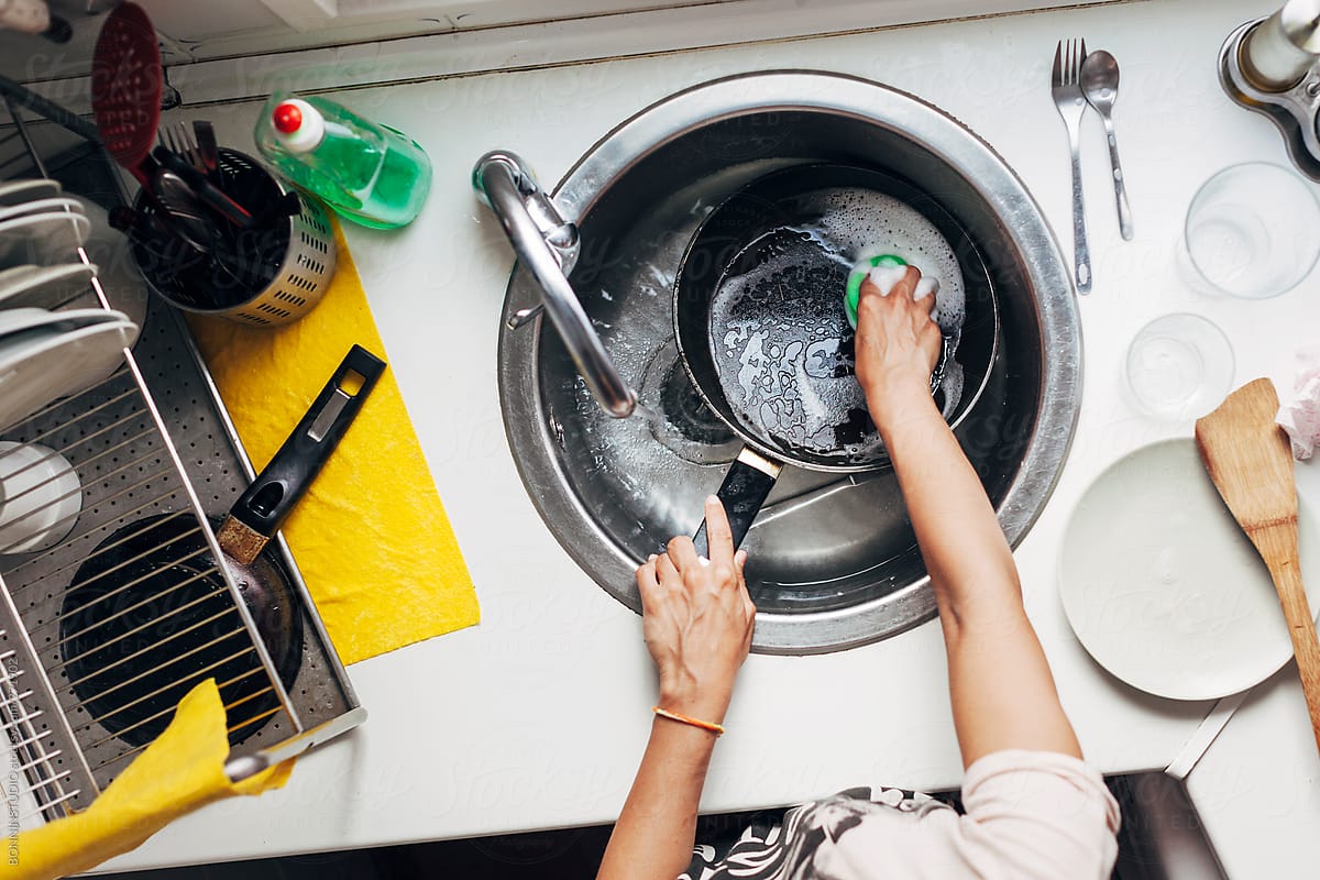 Woman washing dishes.