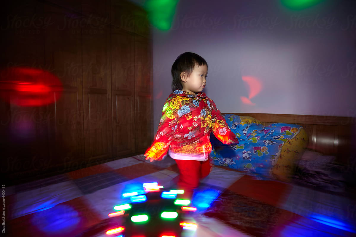 Cute asian little girl dancing at home
