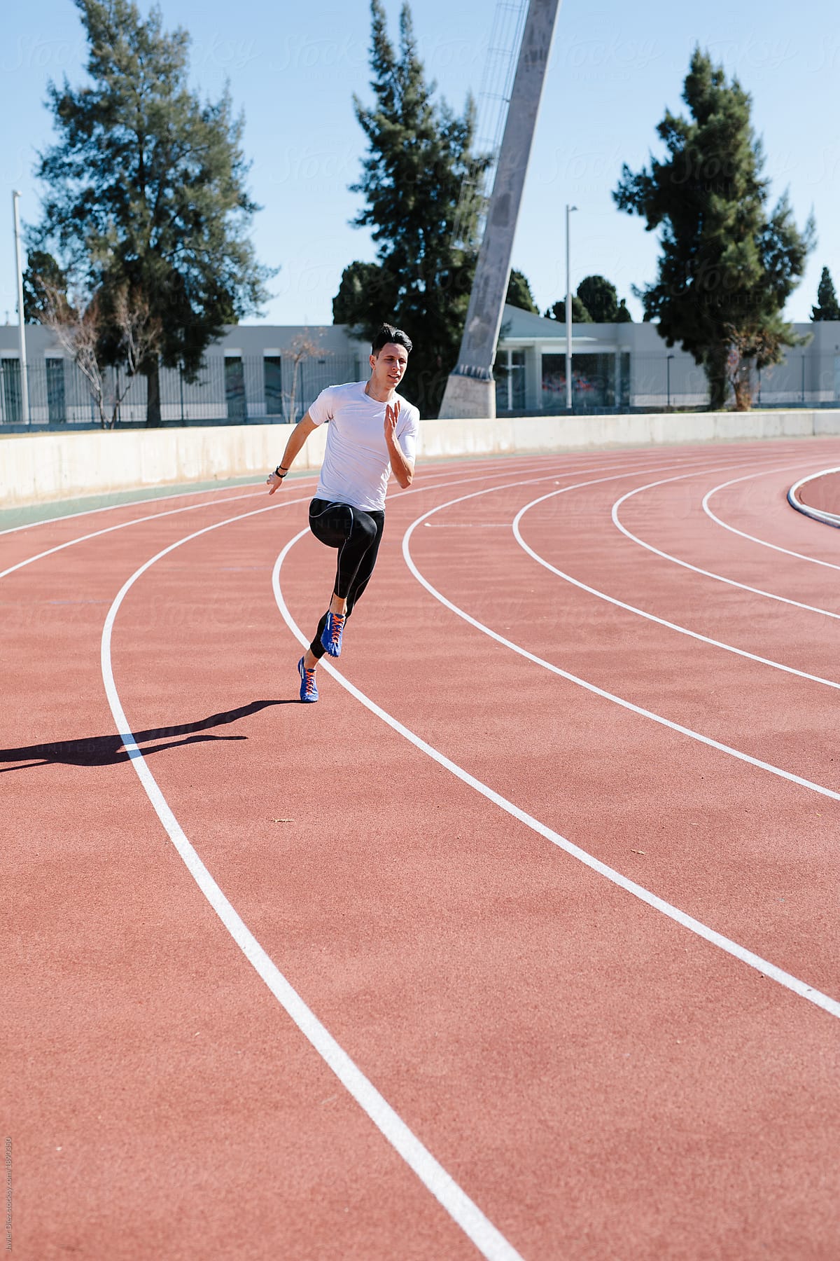 Athletic man sprinting on track