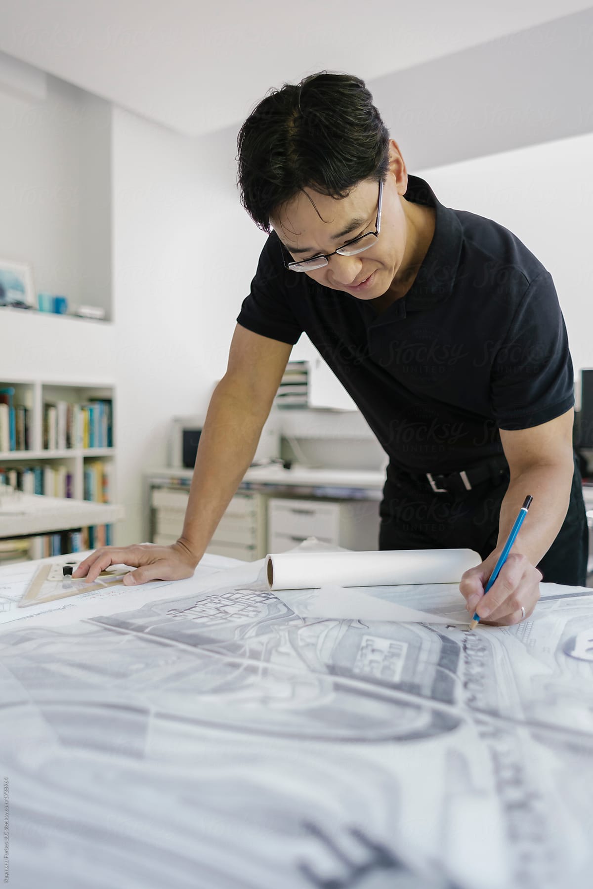 Asian Architect working in Office