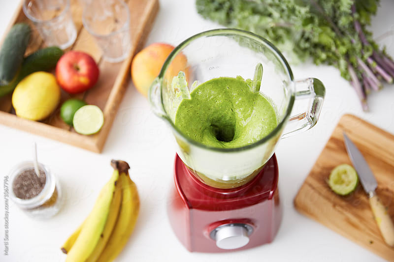 Open mixer with fresh green smoothie