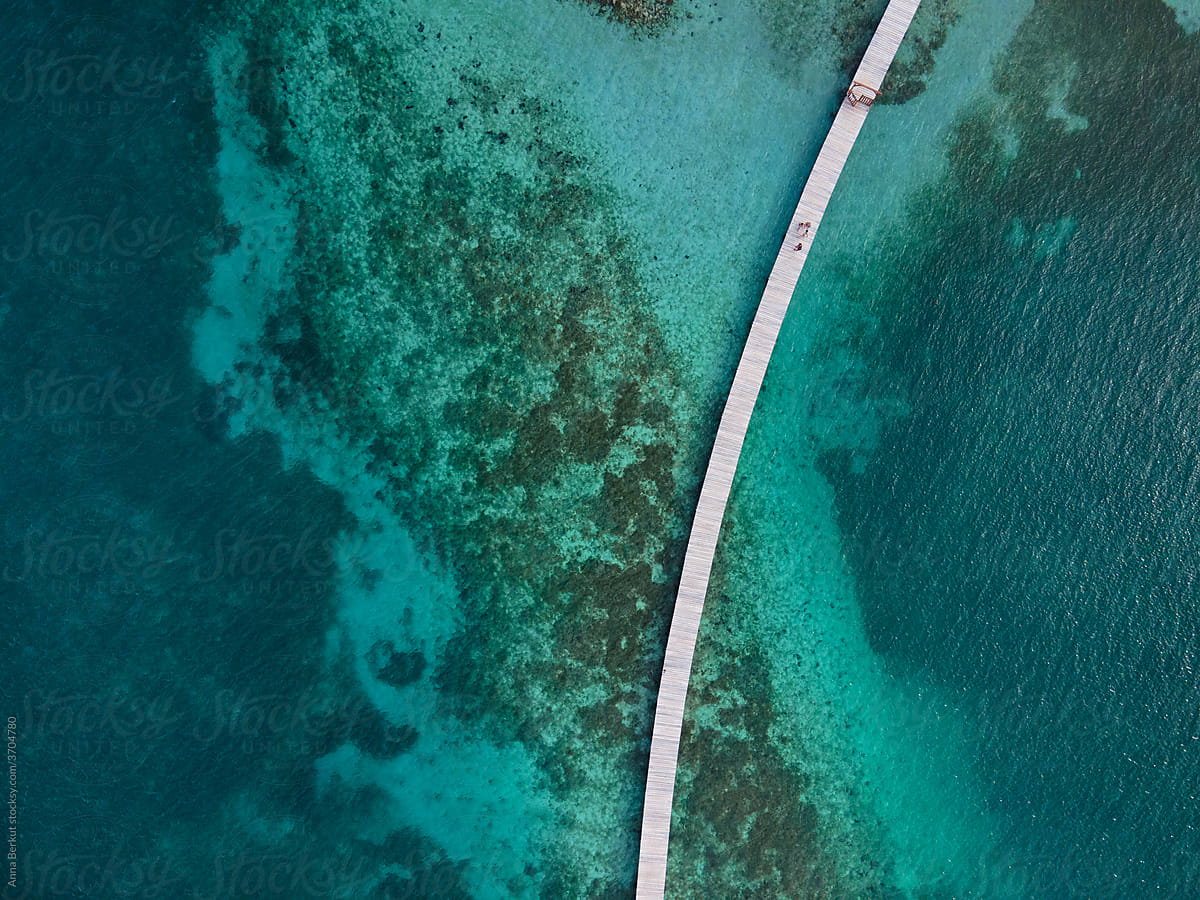wooden pier on coral reef on Caribbean sea beach,  Antilles islands aerial view