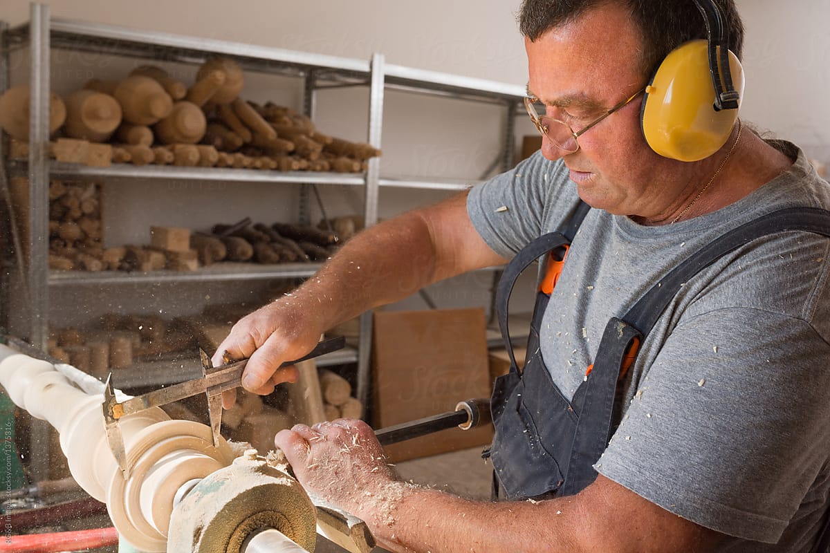Man making custom-made furniture in carpentry workshop