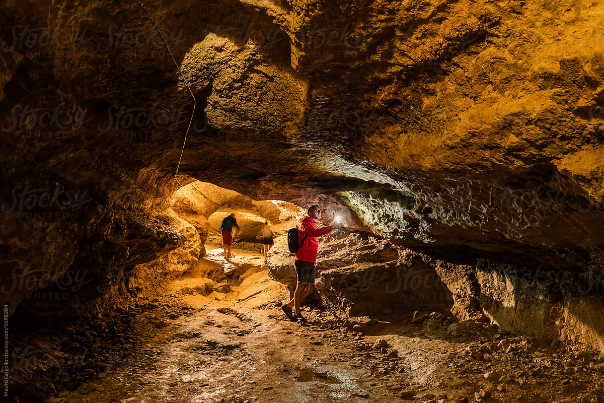 Man exploring a cave inside a mountain