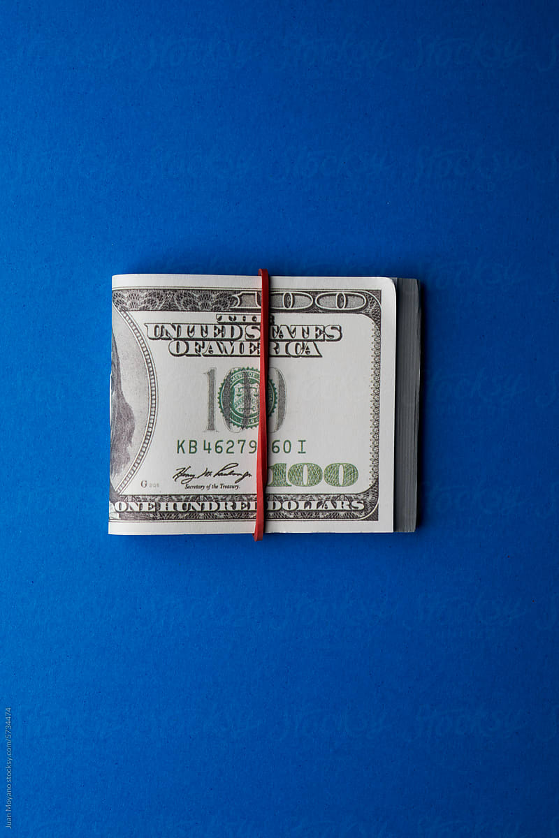 wad of fake dollar bills tied with an elastic band