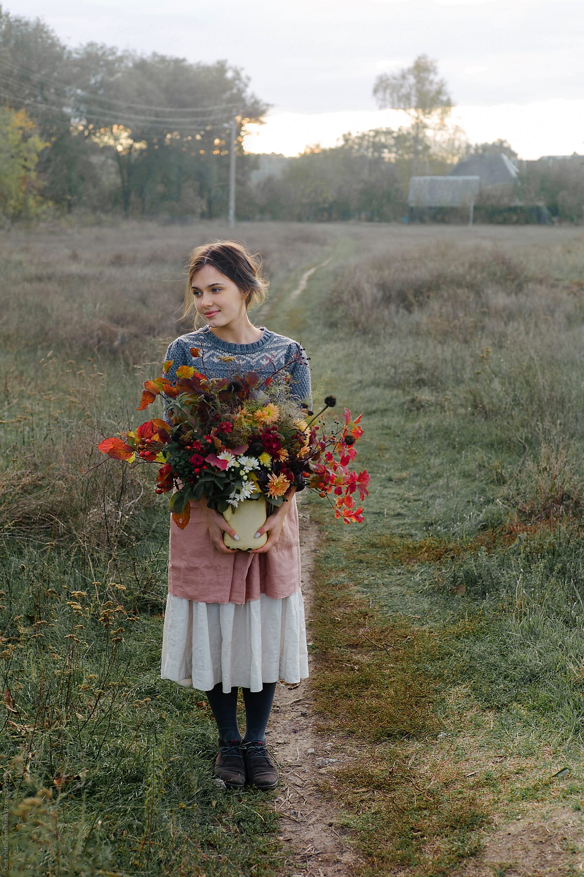 Woman holding bunch of rustic flowers