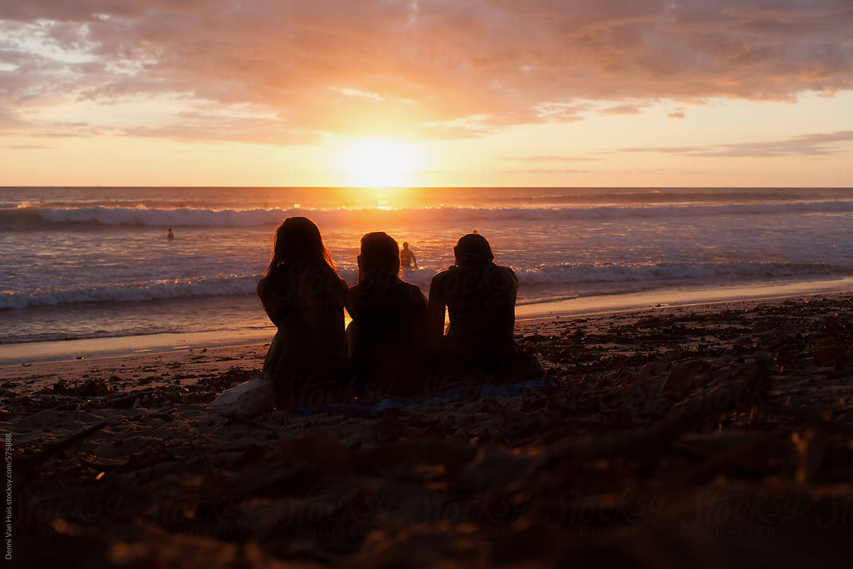 Three Friends Watching The Sunset On The Beach By Denni Van Huis