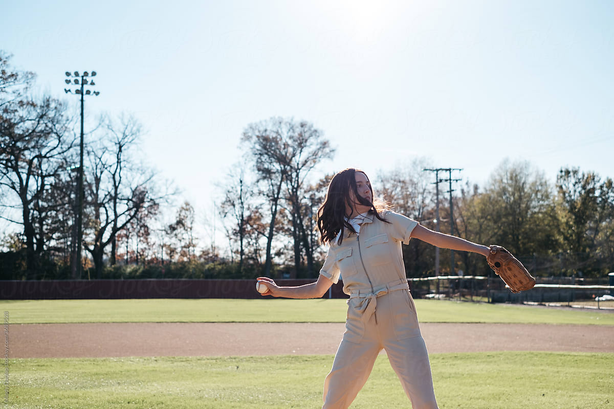 Young woman throwing a baseball