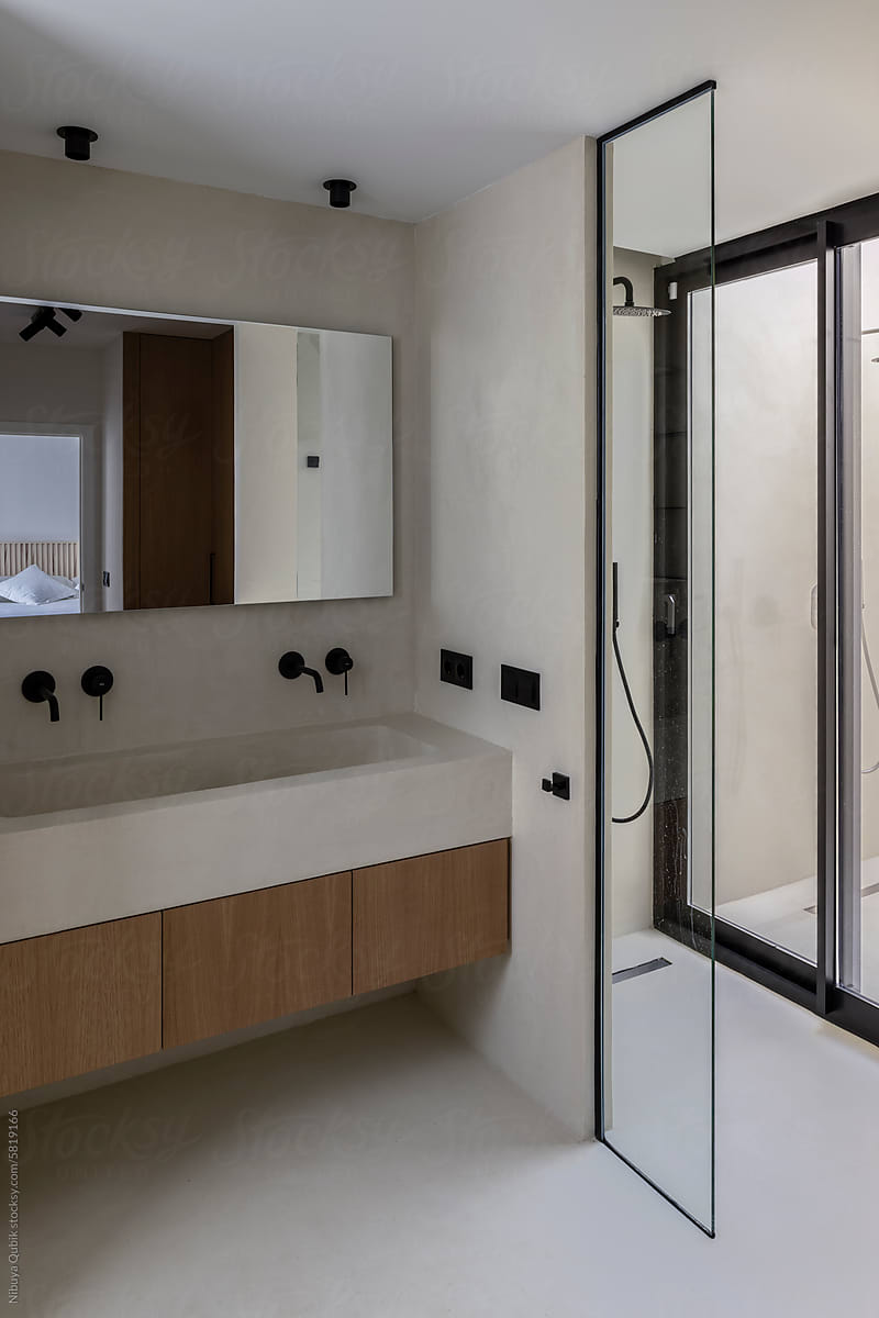 A modern and minimalist bathroom with a skylight shower