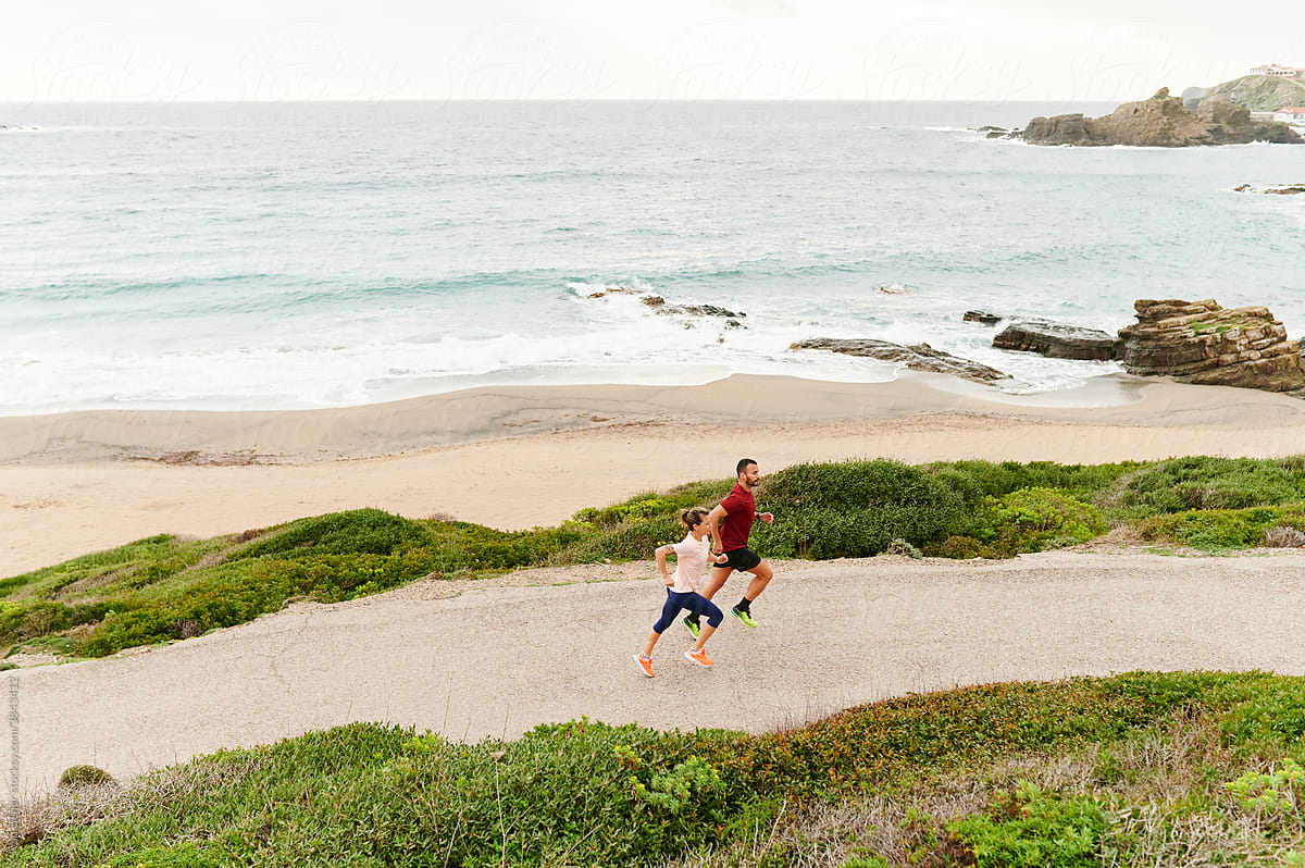 Couple out for a run by the ocean