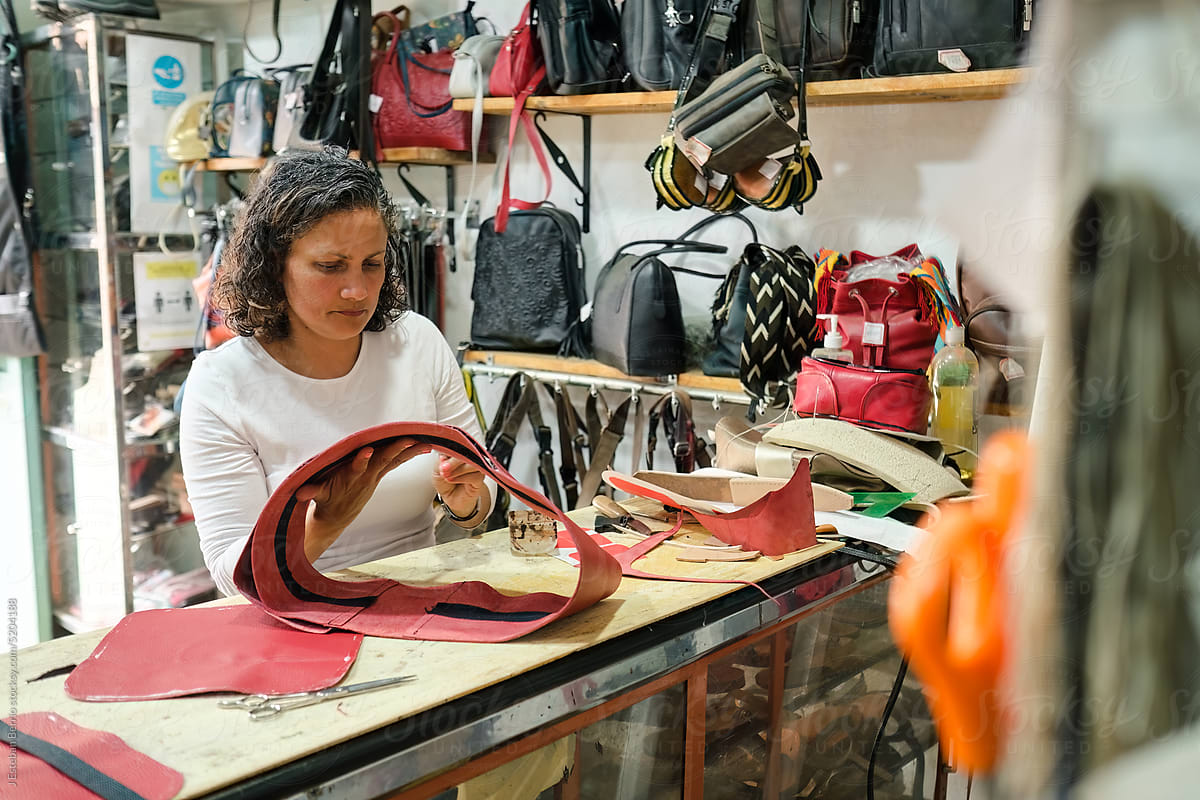 Latina worker making leather bags