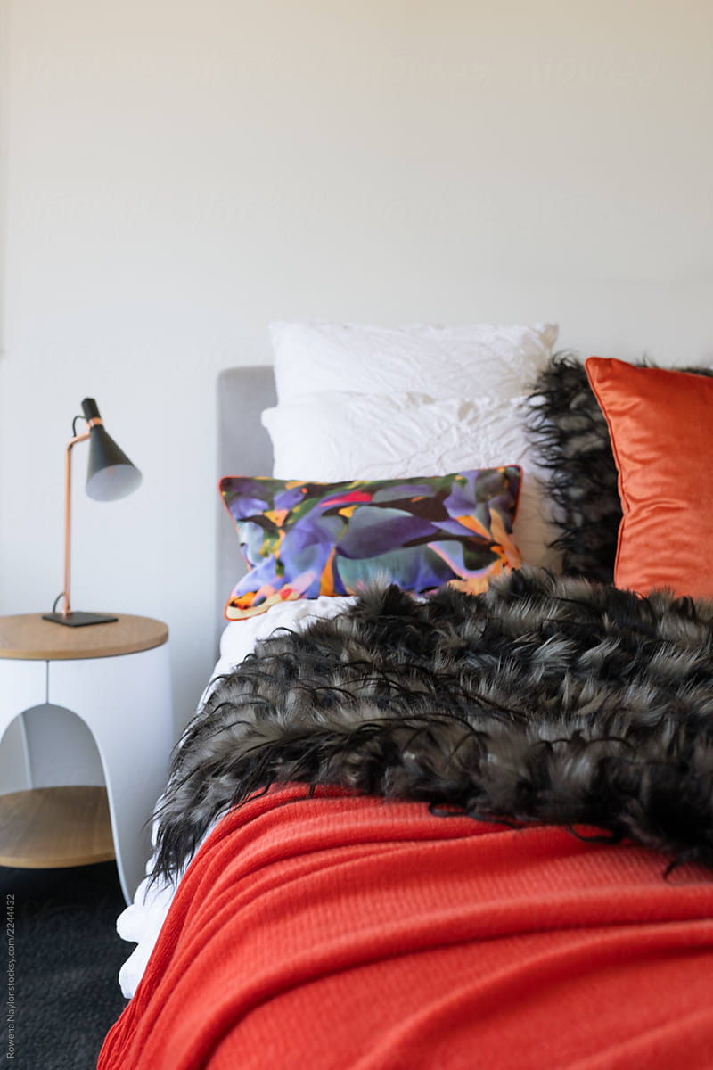 Plush bedroom with orange and black accents