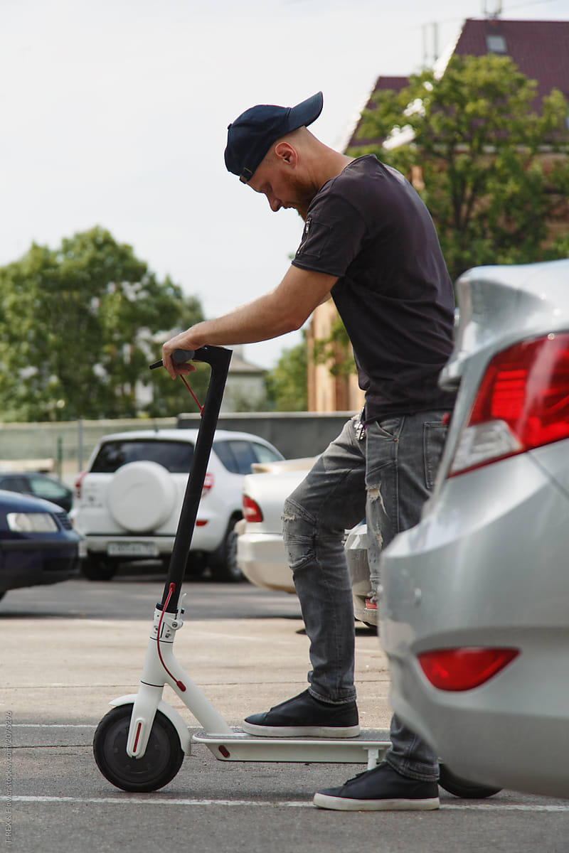 Man preparing to ride kick scooter