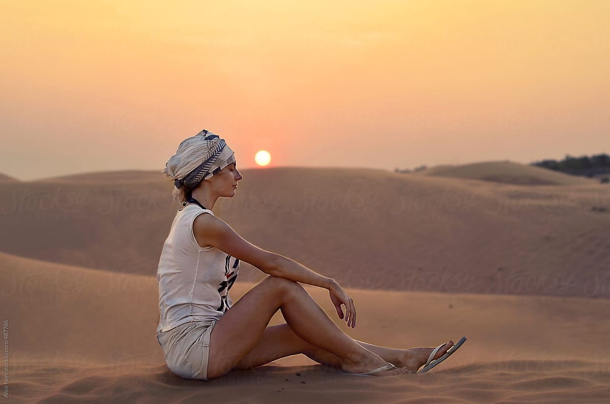 Female at sand dune at sunset