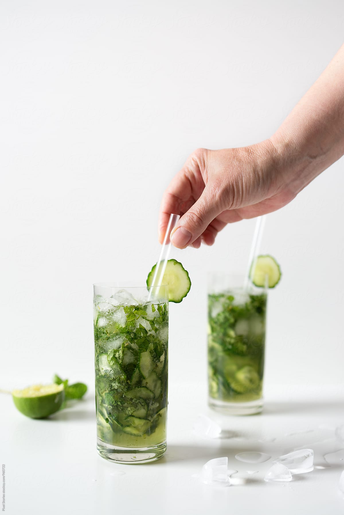 Making cucumber and mint rum mojito cocktail
